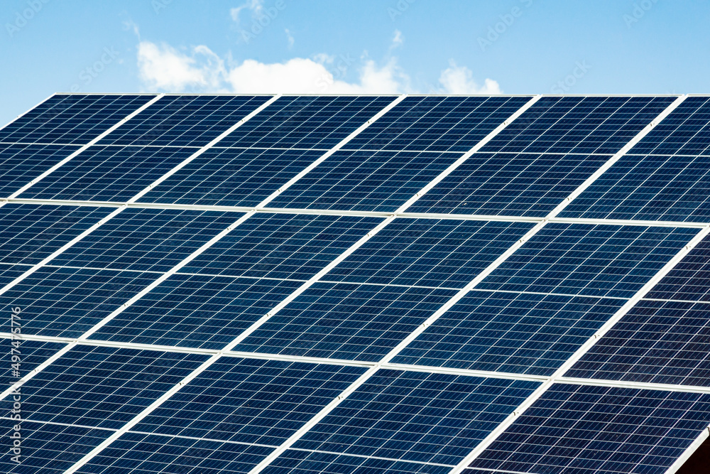Solar panels on the roof of a house close-up. The solar panels are stacked close to each other. Solar panels on the roof of a house close-up. The solar panels are stacked close to each other.