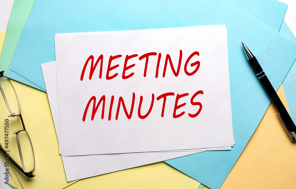 MINUTES OF THE MEETING text on paper on the colorful paper background MINUTES OF THE MEETING text on paper on the colorful paper background