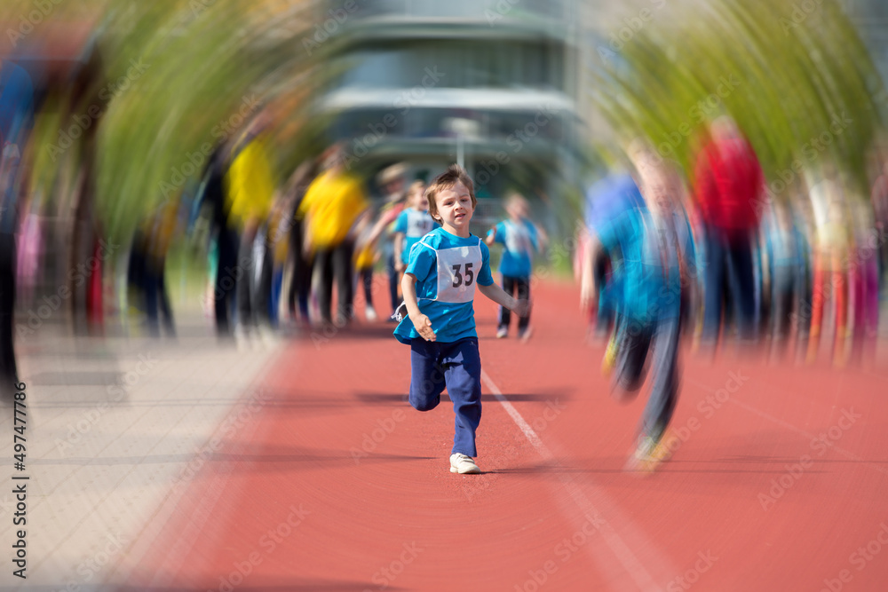 Young preschool children, running on track in a marathon competition, radial blur motion