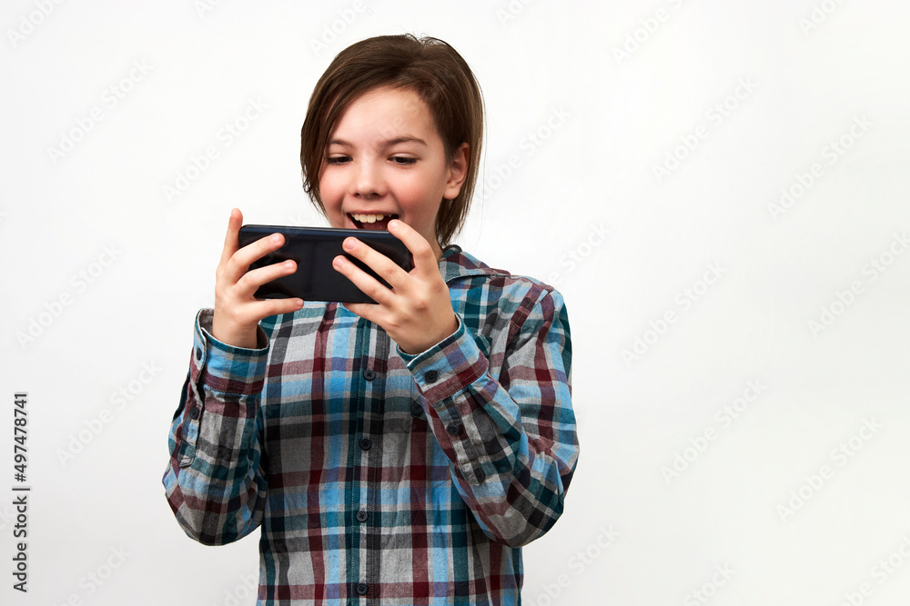 Boy using smartphone on a white background with copy space.