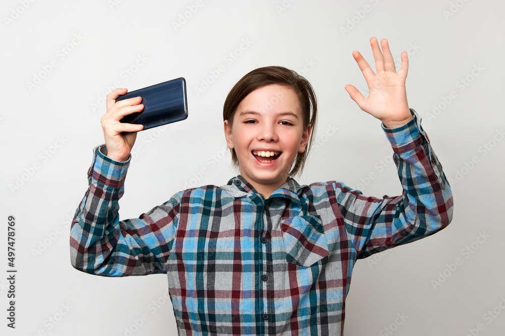 Boy using smartphone on a white background with copy space.