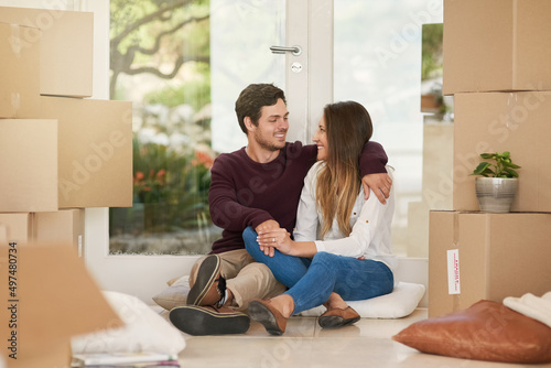 All thats left is the unpacking. Shot of an affectionate young couple taking a break while moving into a new home.