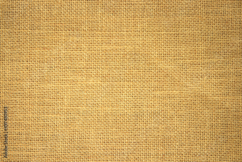 Jute hessian sackcloth burlap canvas woven texture background pattern in light beige cream brown color blank decoration. © siripak