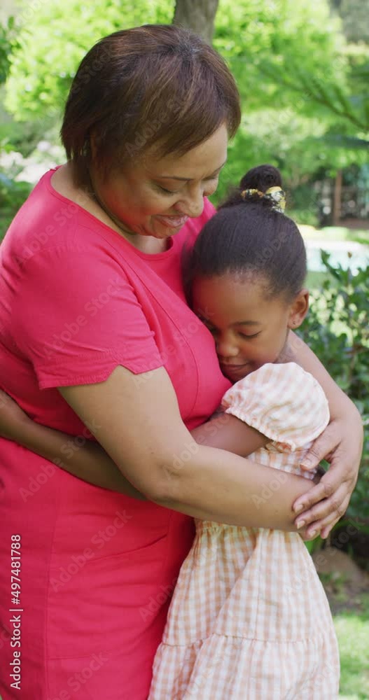 Vertical video of happy african american grandmother and granddaughter embracing Vertical video of happy african american grandmother and granddaughter embracing