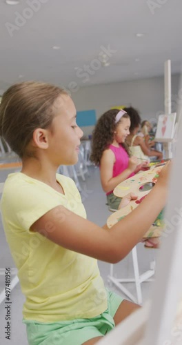 Wallpaper Mural Vertical video of happy diverse schoolgirls painting at school Torontodigital.ca