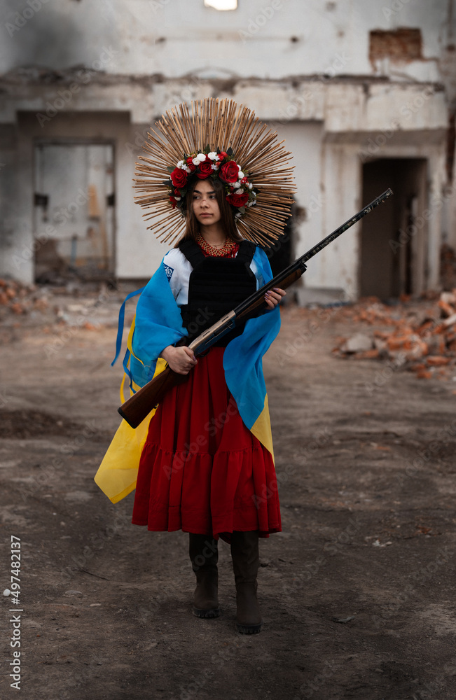 Ukrainian woman in a traditional national costume with a weapon in her hands defending her country and from the aggressor. Ukrainian woman in a traditional national costume with a weapon in her hands defending her country and from the aggressor.