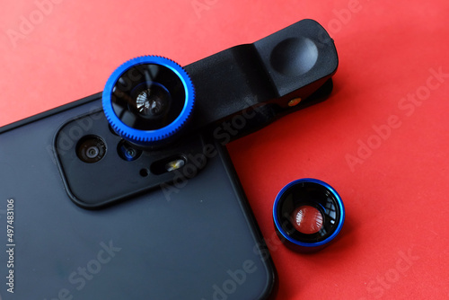 An external lens is attached to a modern smartphone. top view