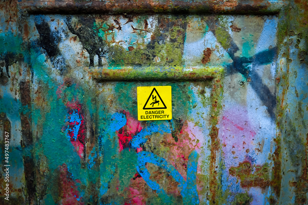 old painted wall with sign danger electricity 