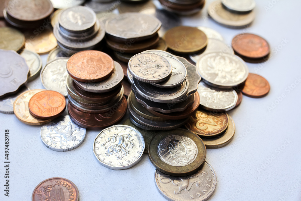 Scattered coins of different countries and stacks of coins with selective focus Scattered coins of different countries and stacks of coins with selective focus