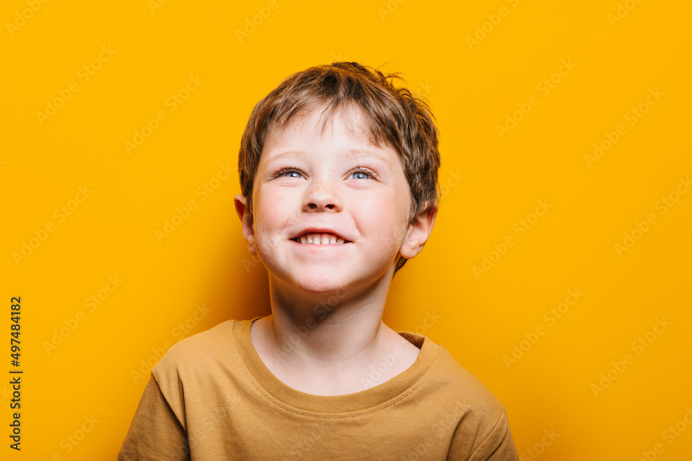 portrait of a happy child on a yellow background portrait of a happy child on a yellow background