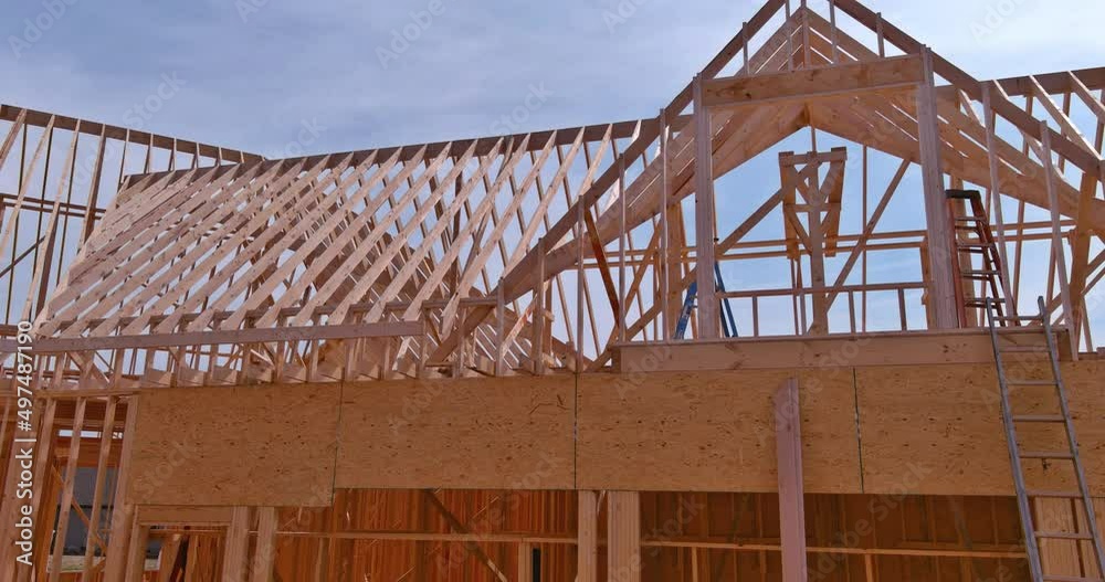 Panorama top view of closeup new wooden roof beams built home under construction under framing with construction site Panorama top view of closeup new wooden roof beams built home under construction under framing with construction site