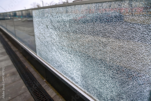 Fotografie Broken glass fence, damaged glass panel with banisters