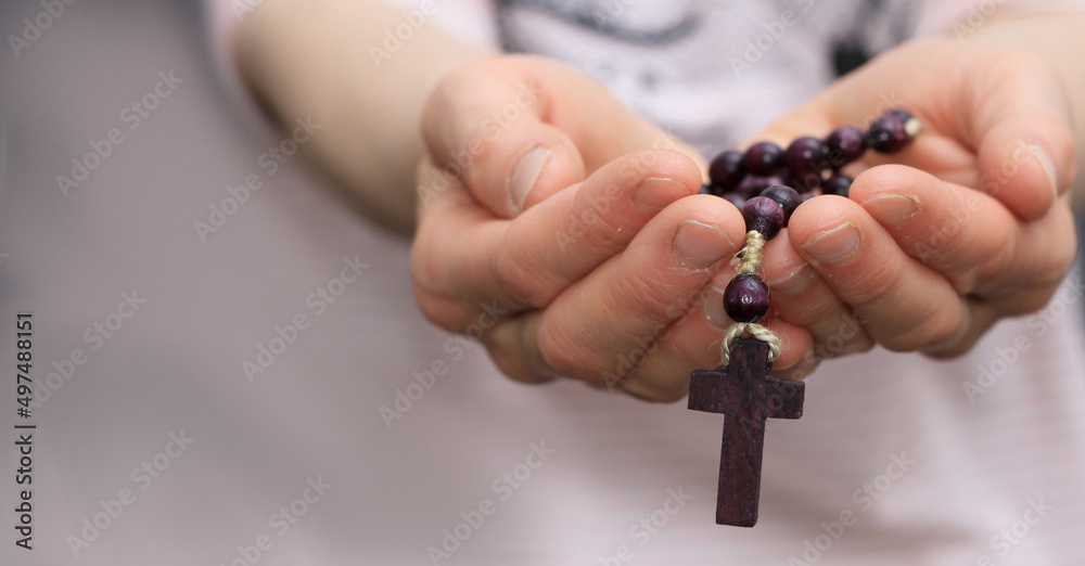 hand holding cross praying to god stock photo