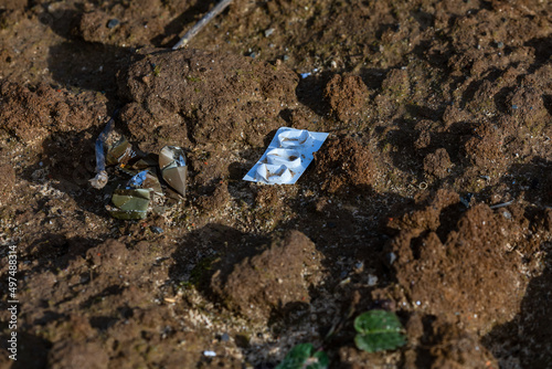 A blister pack of pills in rural field is environmental pollution photo