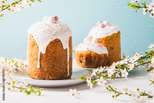Easter cake with glace icing and decoration. Postcard with Easter bread. Christian traditions. Copy space. White background.