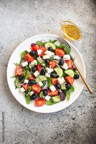 Greek salad of fresh cucumber  tomato  red onion  feta cheese and olives with olive oil. Healthy food  top view