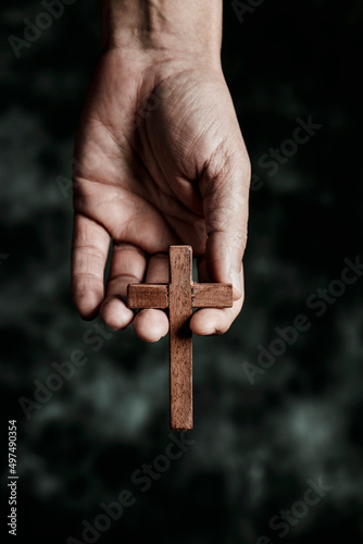 man with a wooden cross in his hand