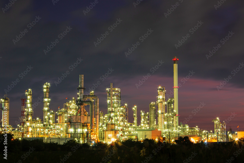 Oil​ refinery​ and​ plant and tower column of Petrochemistry industry in pipeline oil​ and​ gas​ ​industry with​ cloud​ slowing red sky