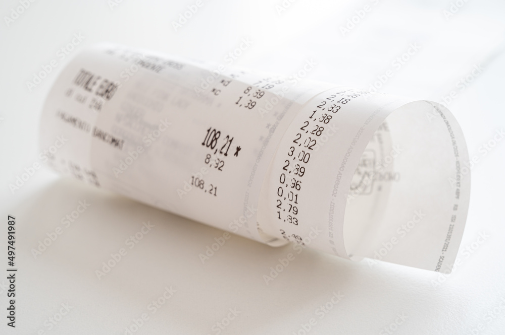 Rolled up shopping receipt, with some amounts visible, on a white surface. Inflation, rising prices and expenses.
Rolled up shopping receipt, with some amounts visible, on a white surface. Inflation, rising prices and expenses.
