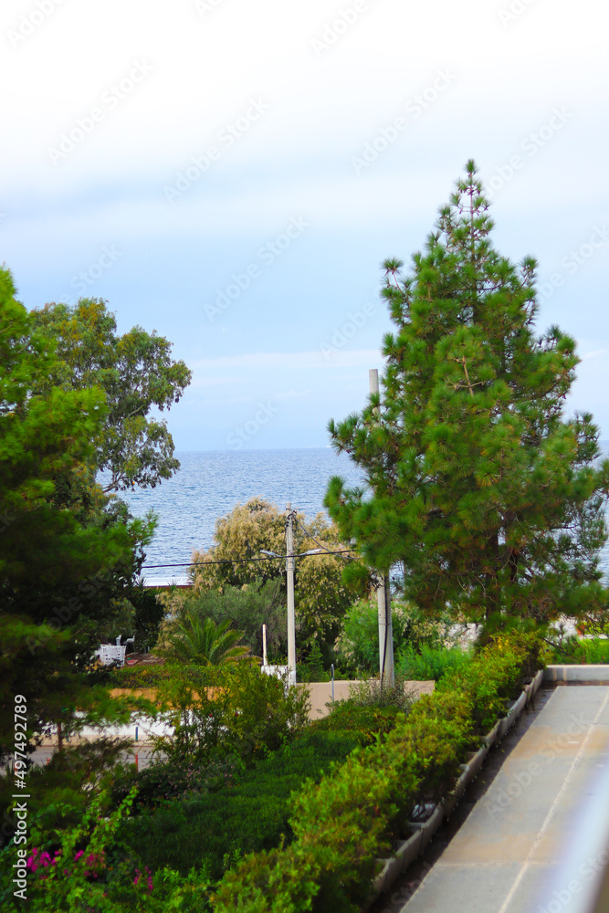 Landscape with scenic view of Saronic Gulf Aegean sea in the historic village of Vouliagmeni, Athens, Greece.