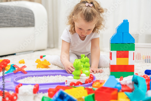 The child is focused on playing with the constructor.