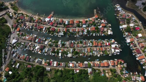 Fishing cottage with boat hus cabins at the ocean or sea on small sandy island. Villages or town of wooden houses in Chengene Skele in Burgas, Bulgaria. Aerial drone flight over a fishing village.  photo