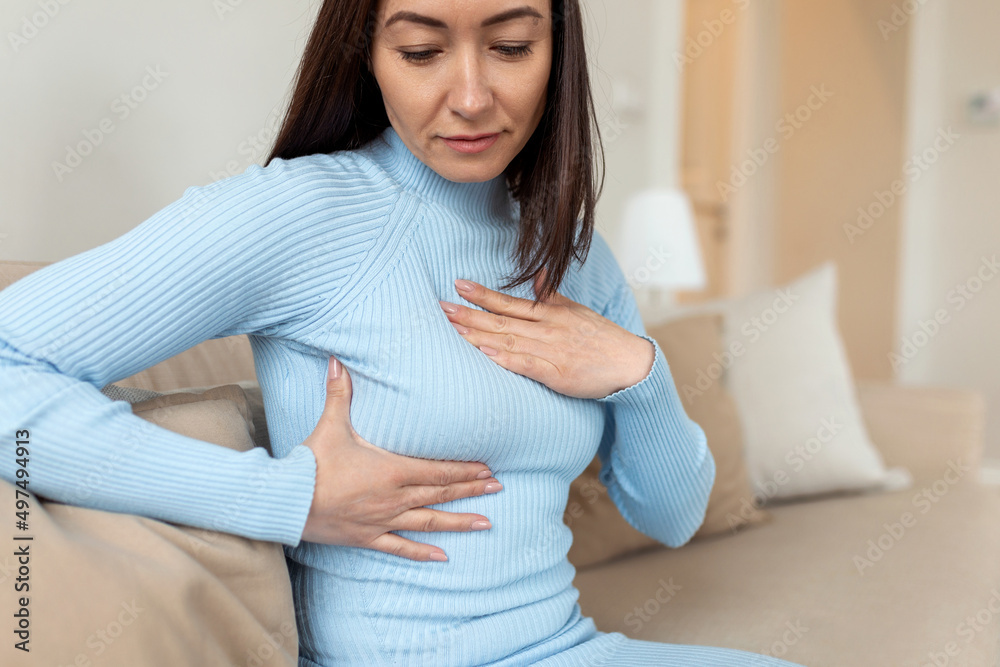 Asian Woman hand checking lumps on her breast for signs of breast cancer. woman is suffering from pain in the breast. BSE or Breast Self-Exam. Guidelines to check for breast cancer. Asian Woman hand checking lumps on her breast for signs of breast cancer. woman is suffering from pain in the breast. BSE or Breast Self-Exam. Guidelines to check for breast cancer.
