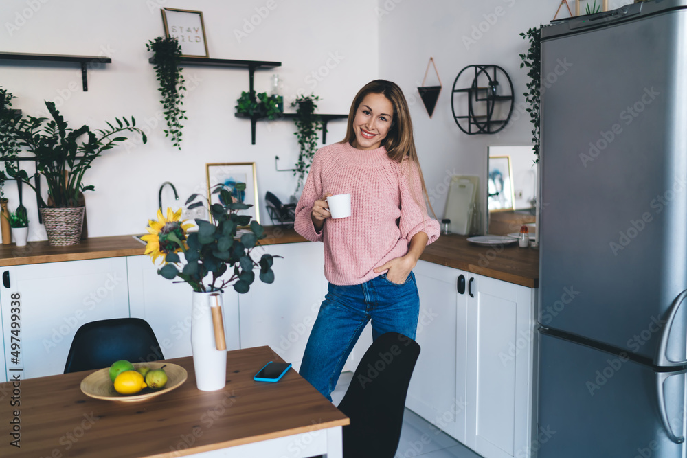 European girl drinking tea from cup at home European girl drinking tea from cup at home