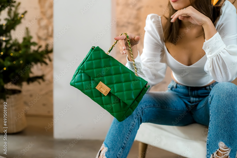 Stylish women's green handbag. Trendy outfit woman with green bag. Girl  with bag over his shoulder outdoors. Shoulder Bags for Women. Fashion look  woman outfit. Close-up. Photos | Adobe Stock