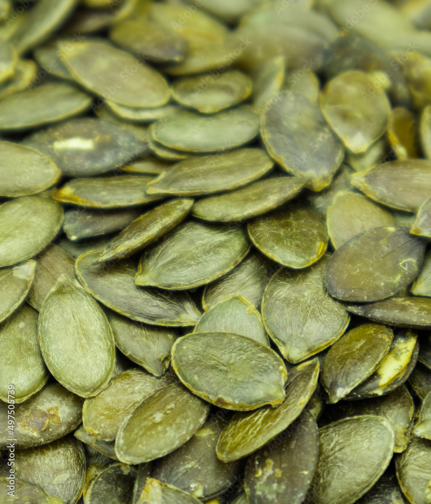 Background texture of green pumpkin seeds. Organic food, selective focus. Background texture of green pumpkin seeds. Organic food, selective focus.