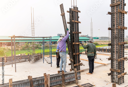 Construction workers installing formwork column pillar photo