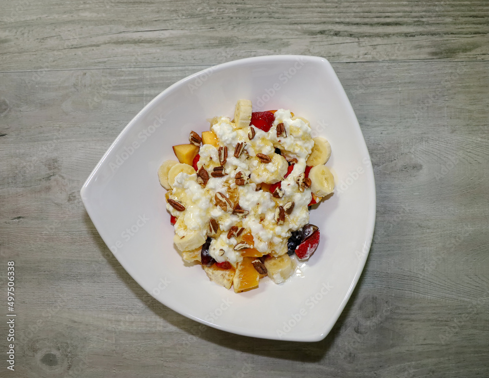 Fruit salad with cottage cheese, honey and pecans.