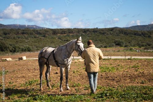 man training a horse on the ranch.