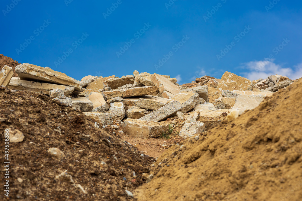 A view of the rubble pile of concrete blocks obtained from the demolition of an old road.