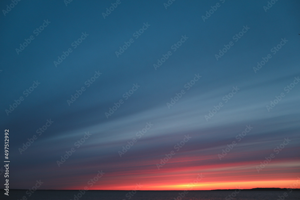 Colorful cloudy sky at the sea at sunset. Gradient color. Sky texture. Beautiful abstract nature sunset as background