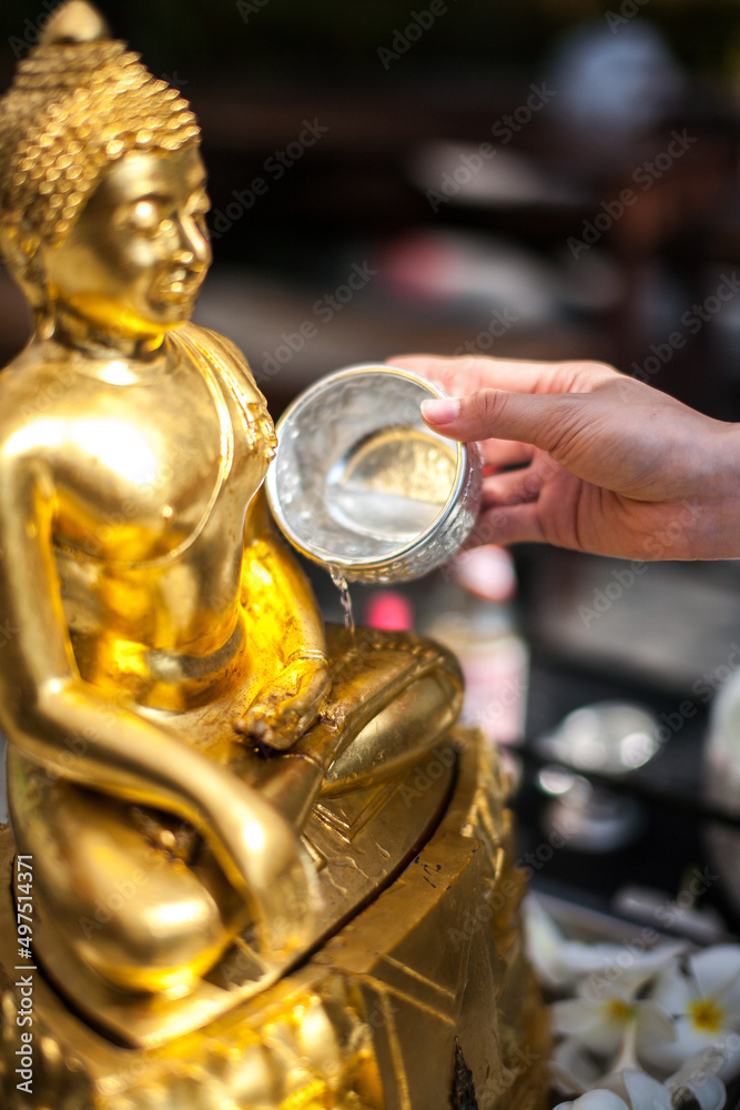 Sprinkle water onto a Golden Buddha Statue in Songkran Festival, is Thailand's most famous festival