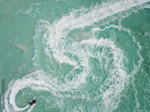 Fotografie, Obraz Bird's eye view of the motorboat trail pattern on the turquoise water surface