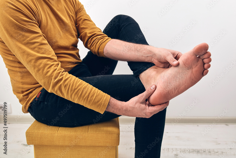 Adult male with foot pain, dislocation, numbness, cramp and other joint issues. Stock Photo