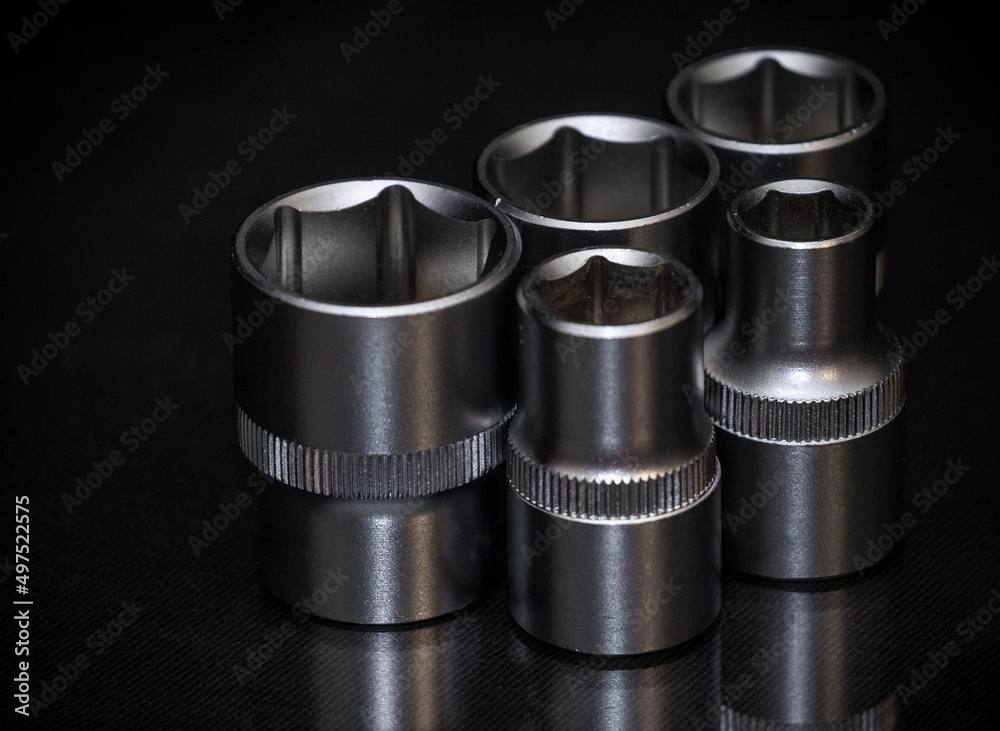 Ratchet wrench on black background. Sockets for socket spanner. Mechanical assembly tool. Ratchet wrench on black background. Sockets for socket spanner. Mechanical assembly tool.