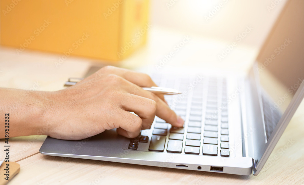 Young start up small business owner writing address on cardboard box at workplace.small business entrepreneur SME , working with box at home, Online selling, e-commerce, packing concept Young start up small business owner writing address on cardboard box at workplace.small business entrepreneur SME , working with box at home, Online selling, e-commerce, packing concept