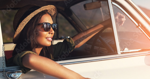 Sunkissed on a road trip. Cropped shot of an attractive young woman enjoying a roadtrip on a sunny day. © Marco V D M/peopleimages.com