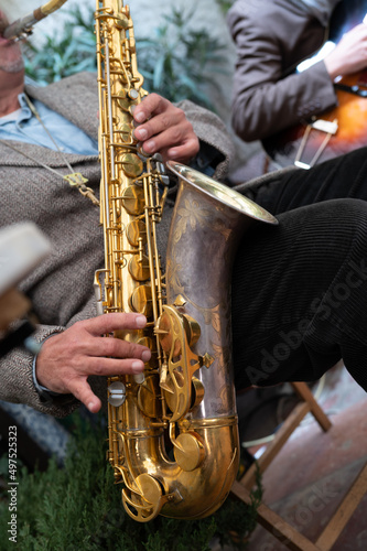 Close-up of a saxophone. Hands playing a saxophone. Musical instruments