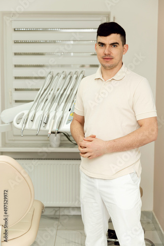 young doctor dentist is in the dental office. highly qualified dentist. portrait of a doctor in the workplace. dental office