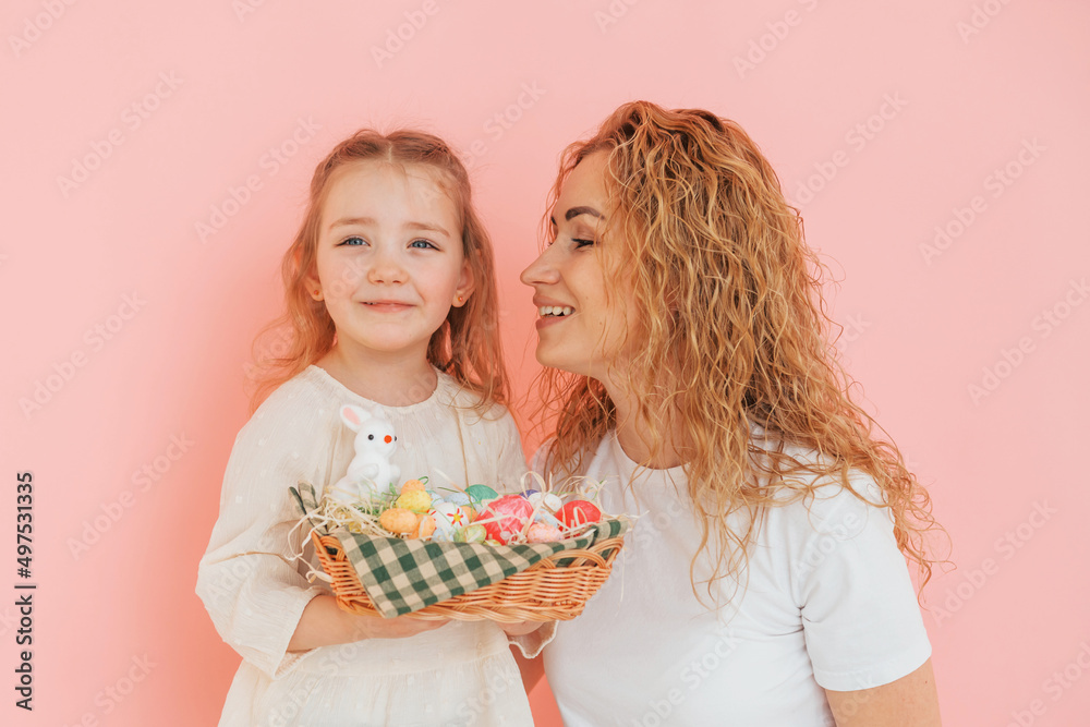Standing against pink background. Happy mother and daugher celebrating Easter holidays together Standing against pink background. Happy mother and daugher celebrating Easter holidays together