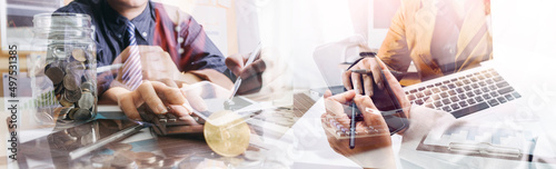 Business people analyzing financial charts and documents in a meeting for the success of company photo