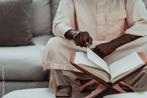African Muslim couple at home in Ramadan reading Quran holly Islam book.