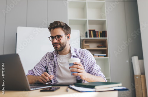 Millennial businessman working at desk in office