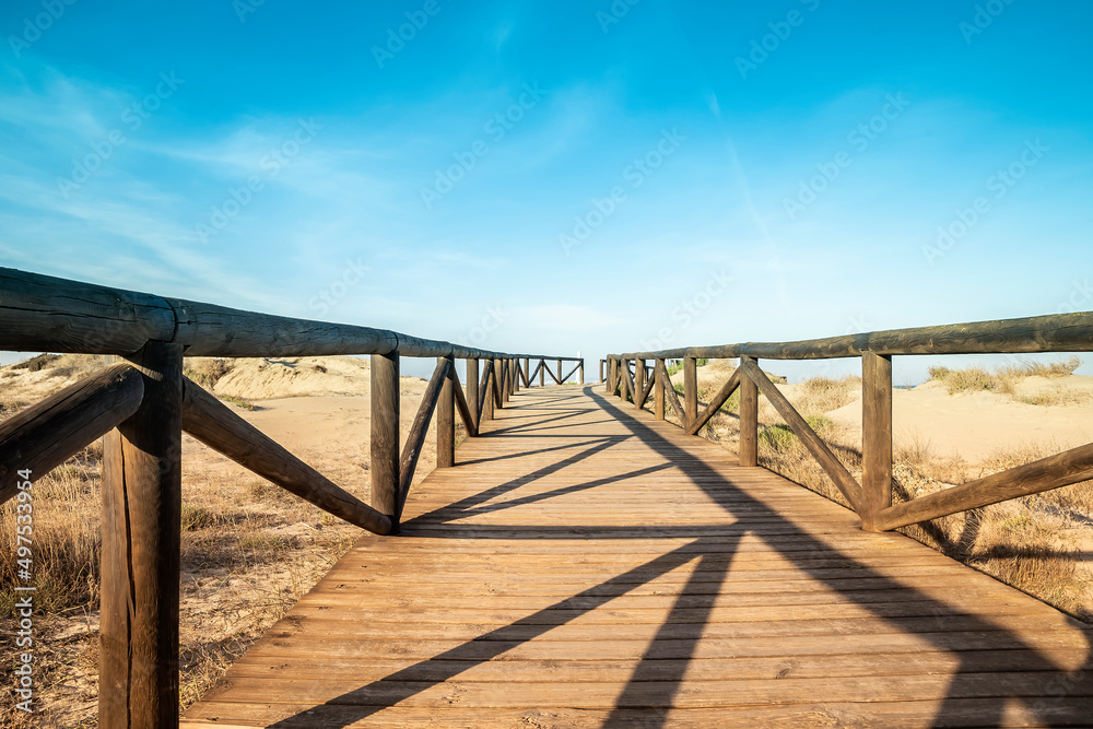 bottom view wooden footbridge leading to the sea over the sand in Guardamar del segura. Alicante, Spain