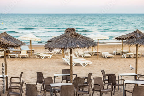 solitude terrace bar in the beach wit straw umbrellas and beach loungers