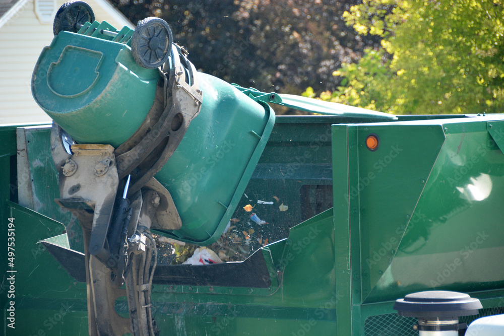 Garbage Can Being Dumped into a Garbage Truck Garbage Can Being Dumped into a Garbage Truck